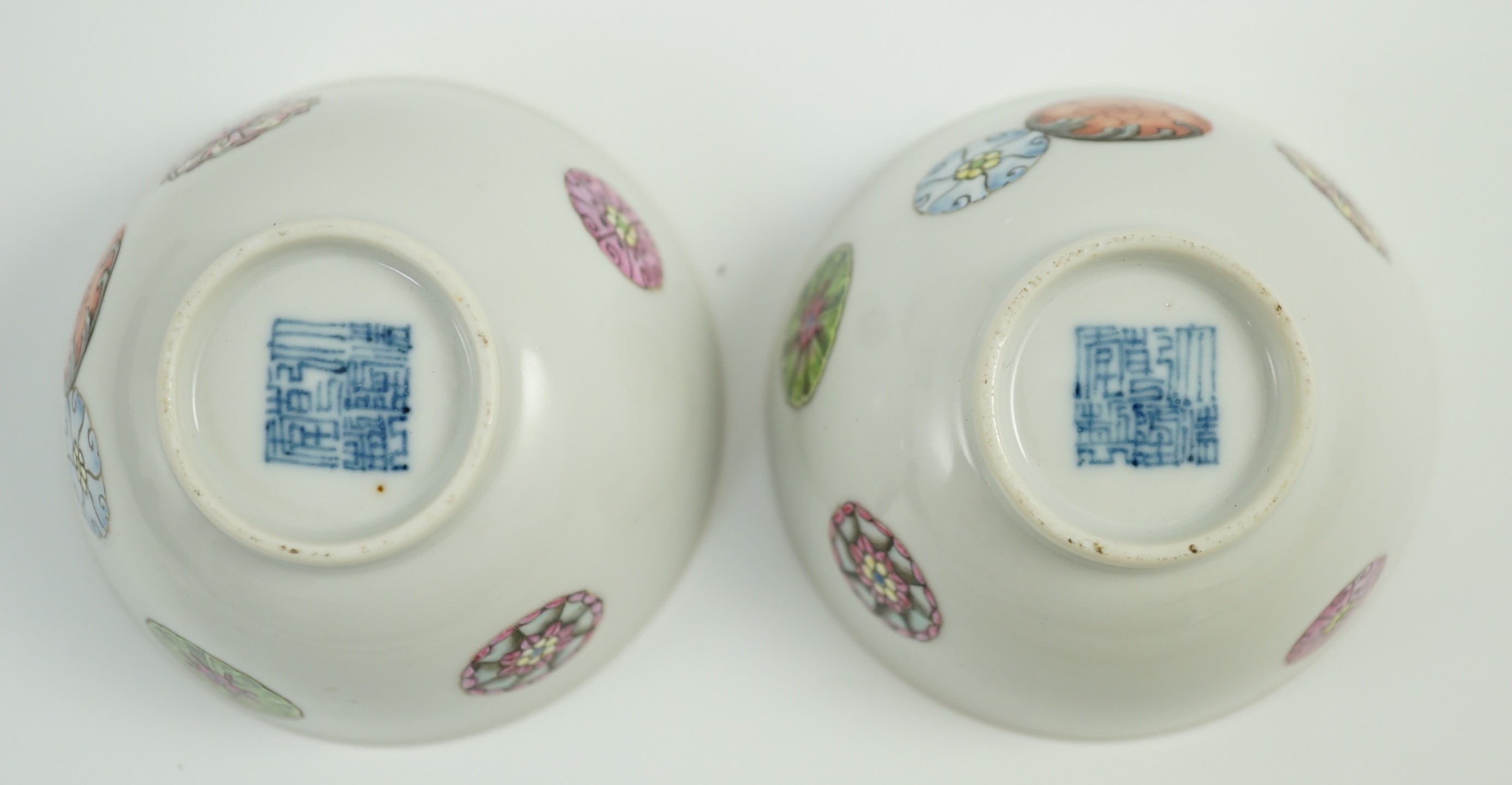 A pair of Chinese enamelled porcelain tea bowls, Qianlong seal marks, 7cms diameter